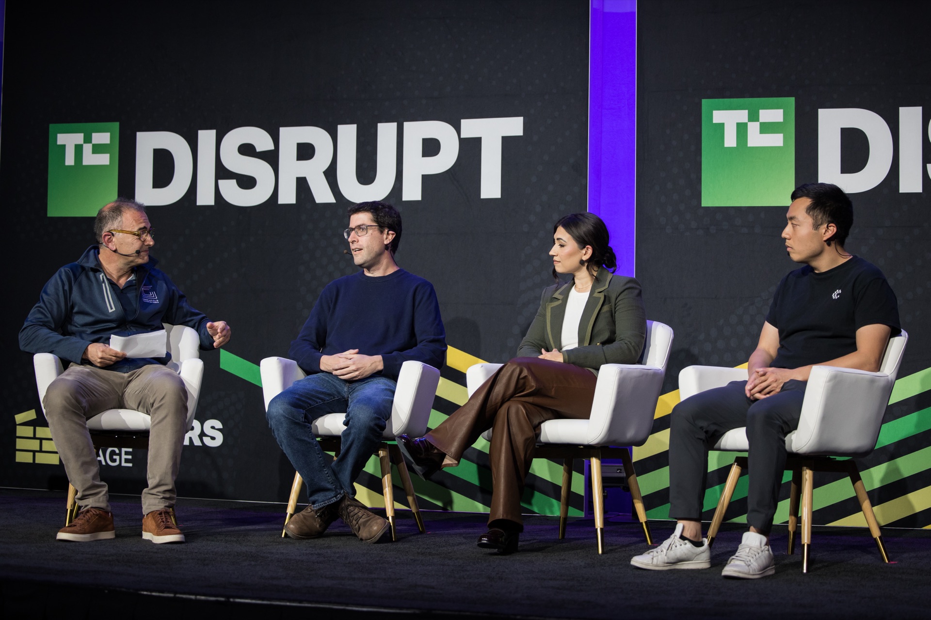 TechCrunch Disrupt stage panel, four speakers before the Disrupt backdrop